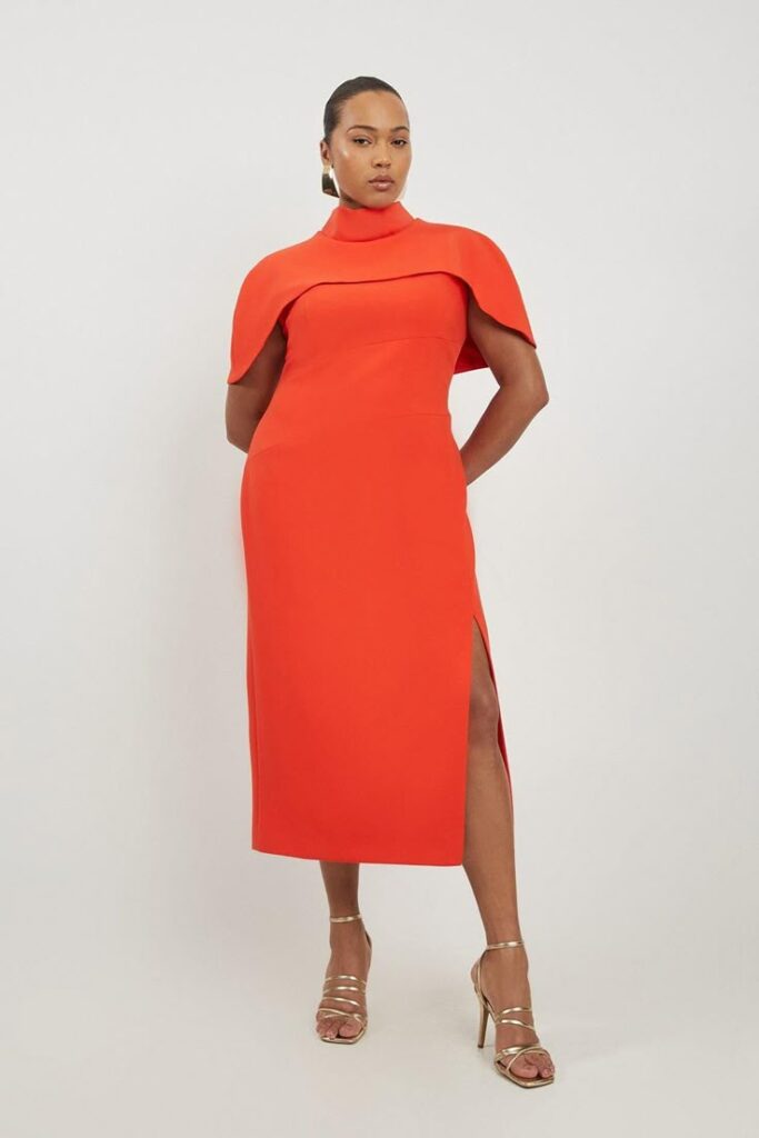 A beautiful red dress with a topper that is a great example of an officiant outfit option.
