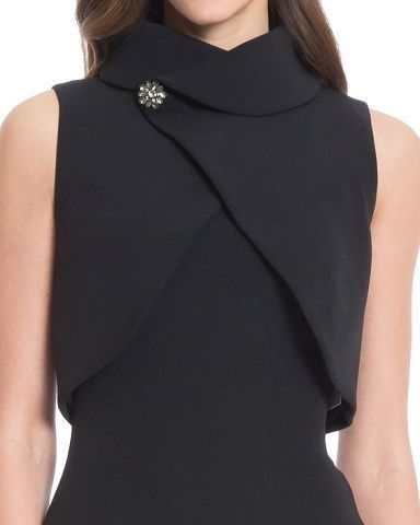 A black dress with a topper or mock neck shrug. A great wedding officiant outfit option.